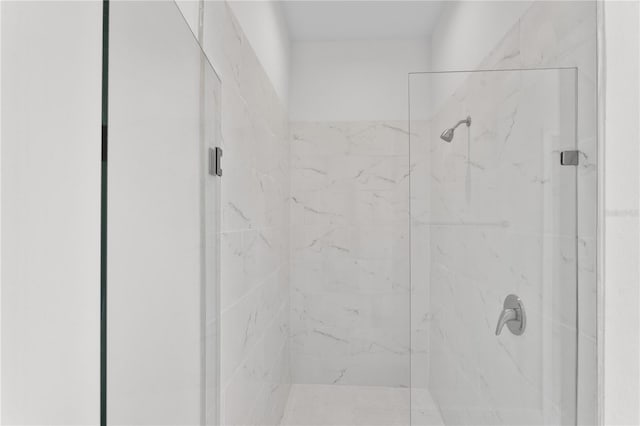 full bath with a marble finish shower