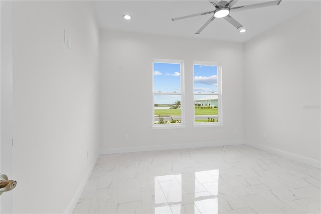 empty room featuring recessed lighting, baseboards, marble finish floor, and a ceiling fan