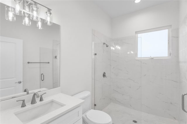 bathroom featuring a marble finish shower, toilet, and vanity