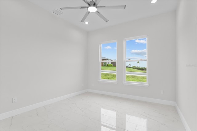 spare room featuring recessed lighting, baseboards, and marble finish floor