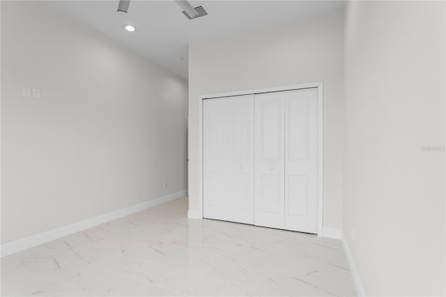 unfurnished bedroom featuring visible vents, baseboards, recessed lighting, a closet, and marble finish floor