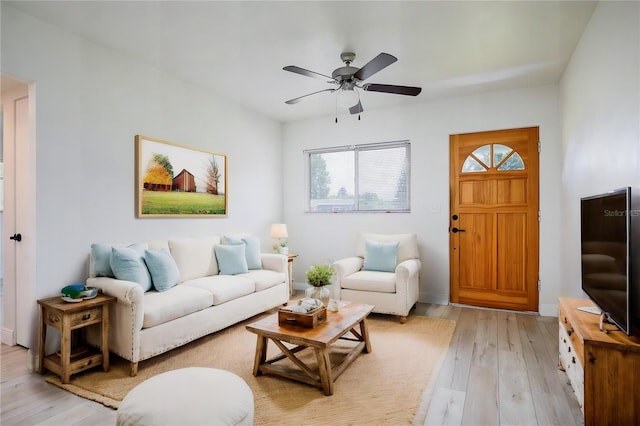 living room with ceiling fan and light hardwood / wood-style flooring