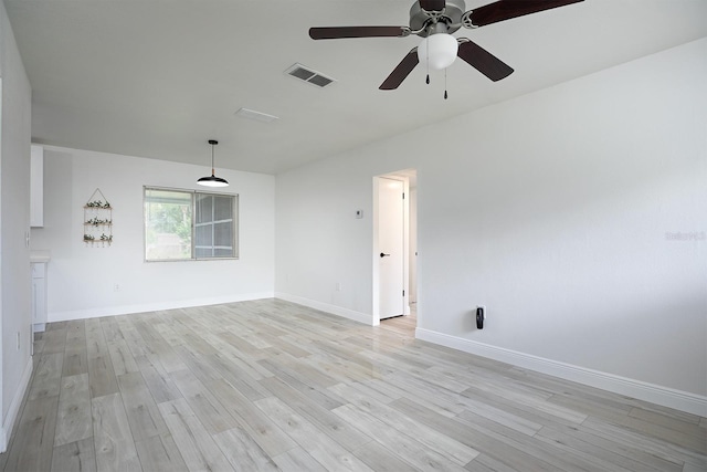 spare room featuring light hardwood / wood-style flooring and ceiling fan