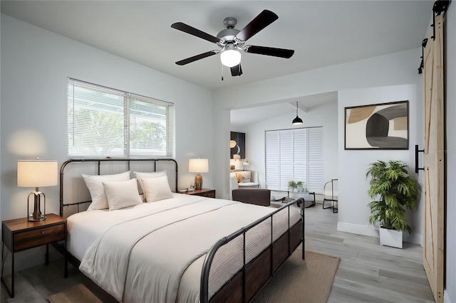 bedroom with lofted ceiling, light hardwood / wood-style flooring, and ceiling fan