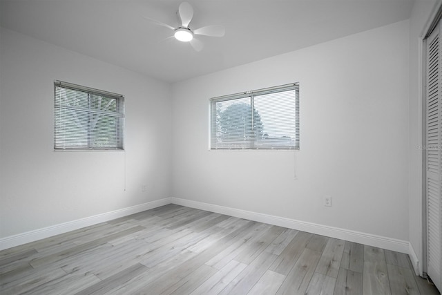 spare room with light wood-type flooring and ceiling fan