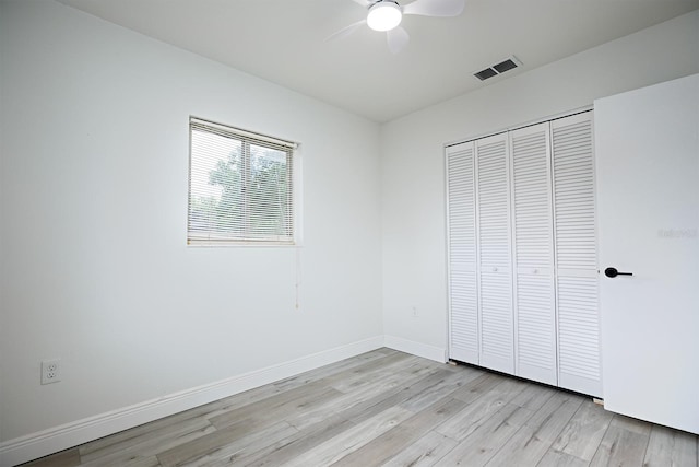 unfurnished bedroom with ceiling fan, light hardwood / wood-style floors, and a closet