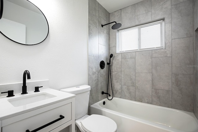 full bathroom featuring toilet, vanity, and tiled shower / bath