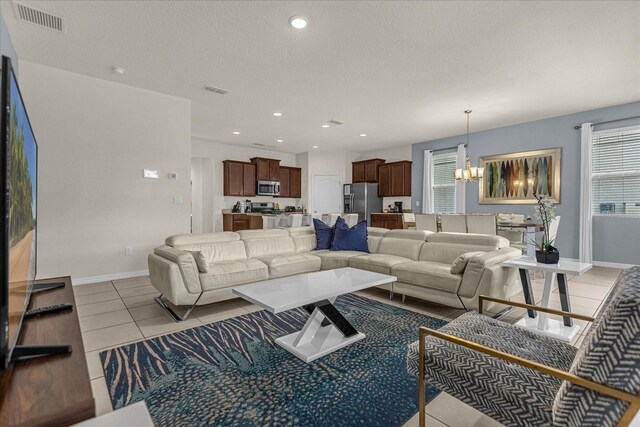 tiled living room featuring a chandelier