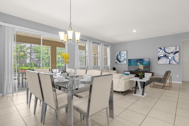 dining room with light tile patterned floors and a notable chandelier