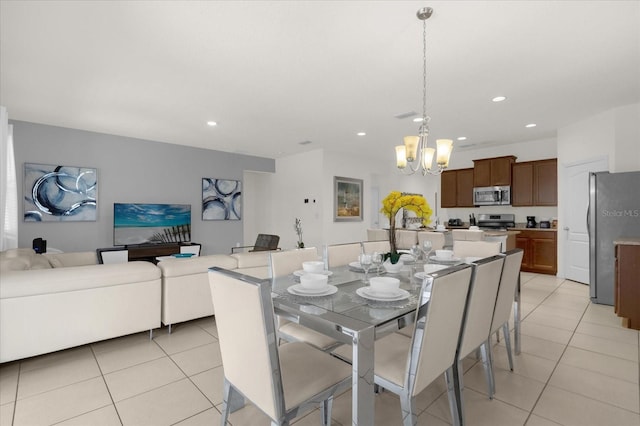 tiled dining area featuring an inviting chandelier