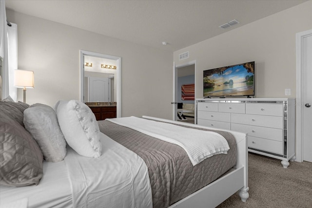 carpeted bedroom with ensuite bath