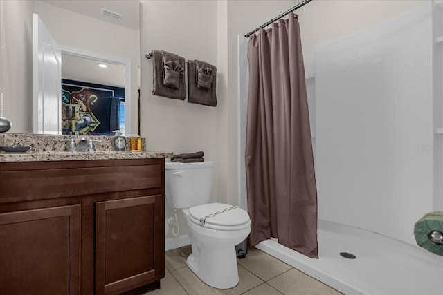 bathroom featuring tile patterned flooring, vanity, a shower with shower curtain, and toilet