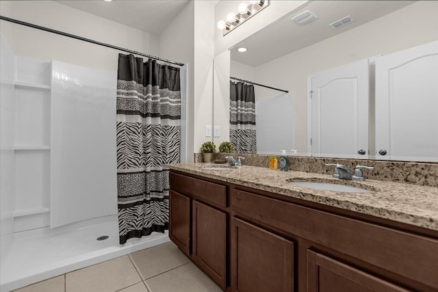 bathroom featuring a shower with curtain, vanity, and tile patterned flooring