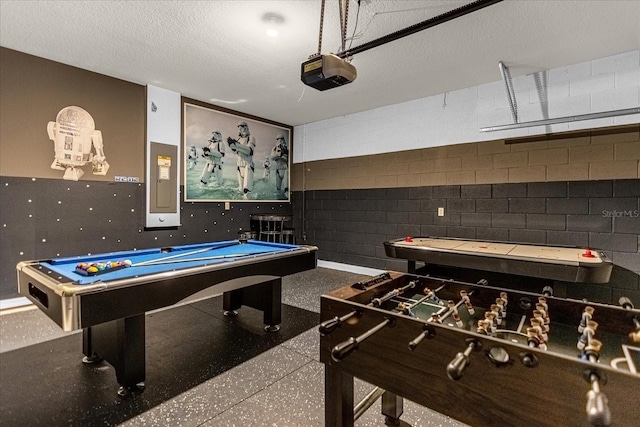 playroom featuring electric panel, a textured ceiling, and billiards