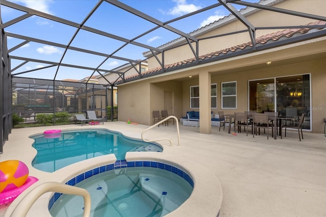 view of swimming pool featuring an in ground hot tub, a lanai, outdoor lounge area, and a patio