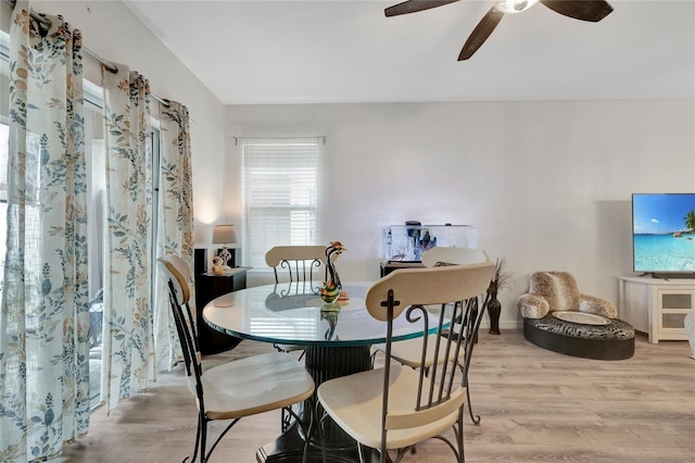 dining space featuring ceiling fan and light wood-type flooring