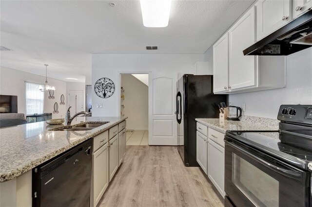 kitchen with light hardwood / wood-style floors, sink, black appliances, and light stone countertops