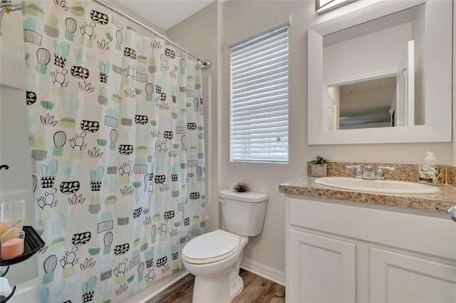 full bathroom with vanity, hardwood / wood-style floors, shower / tub combo, and toilet