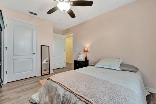 bedroom with light hardwood / wood-style flooring and ceiling fan