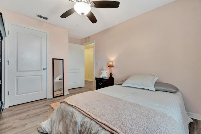 bedroom with ceiling fan and light hardwood / wood-style floors