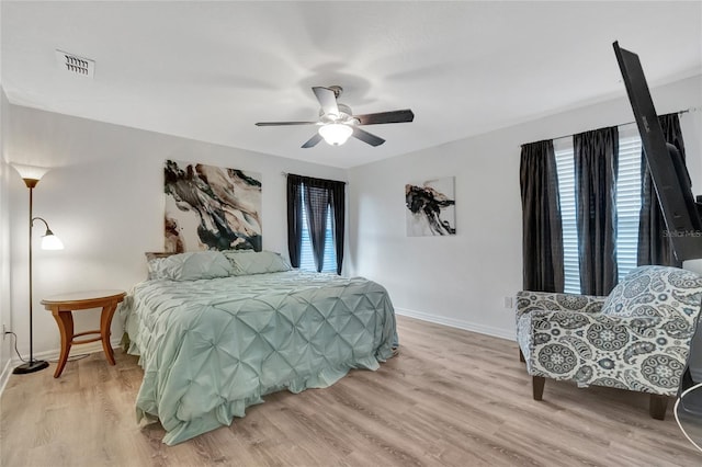 bedroom with light hardwood / wood-style flooring and ceiling fan