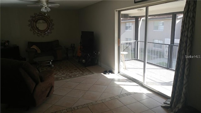 living room featuring ceiling fan, a wealth of natural light, and light tile patterned floors