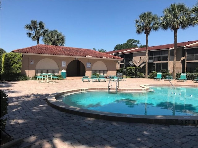 view of swimming pool with a patio area