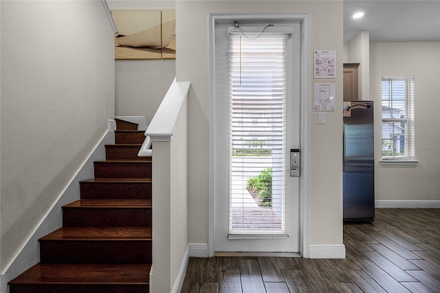 stairs with dark hardwood / wood-style flooring