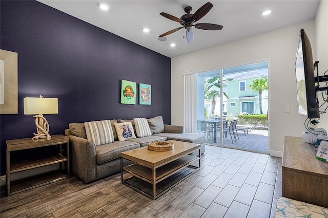 living room with wood-type flooring and ceiling fan