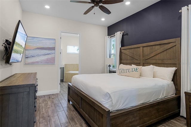 bedroom with ensuite bath, dark wood-type flooring, and ceiling fan