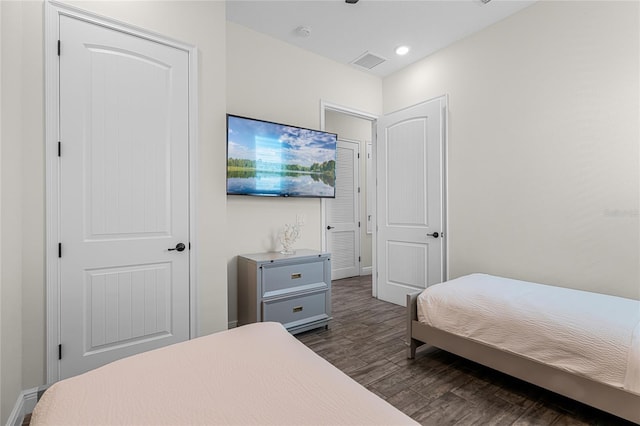 bedroom with dark hardwood / wood-style flooring