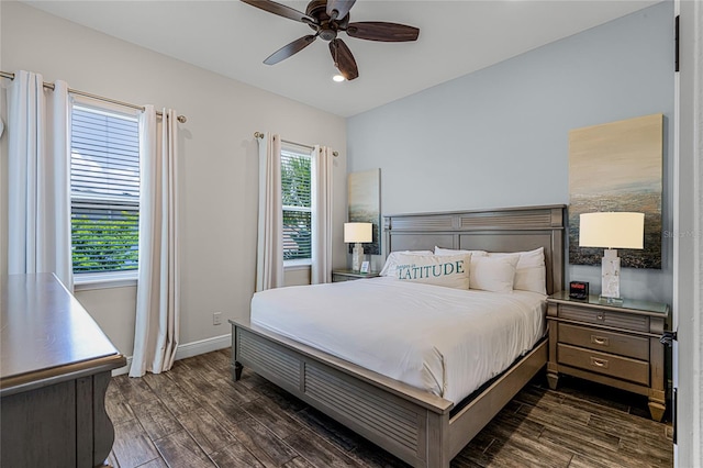 bedroom with dark hardwood / wood-style floors and ceiling fan