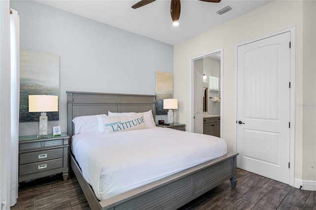 bedroom featuring dark hardwood / wood-style floors, connected bathroom, and ceiling fan