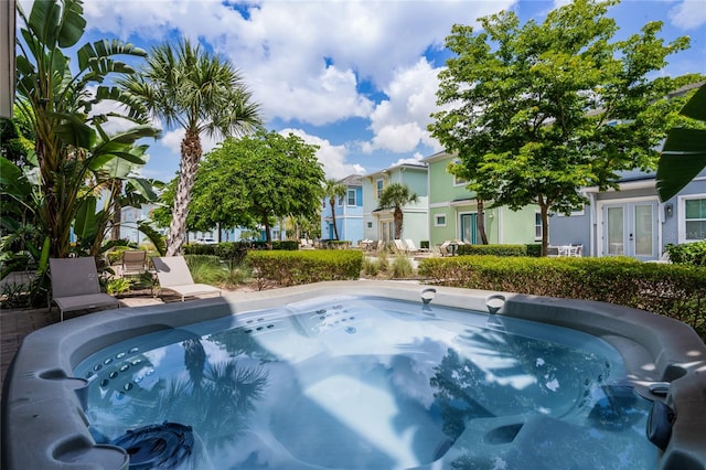 view of swimming pool featuring a hot tub