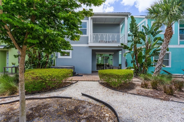 back of property featuring a balcony