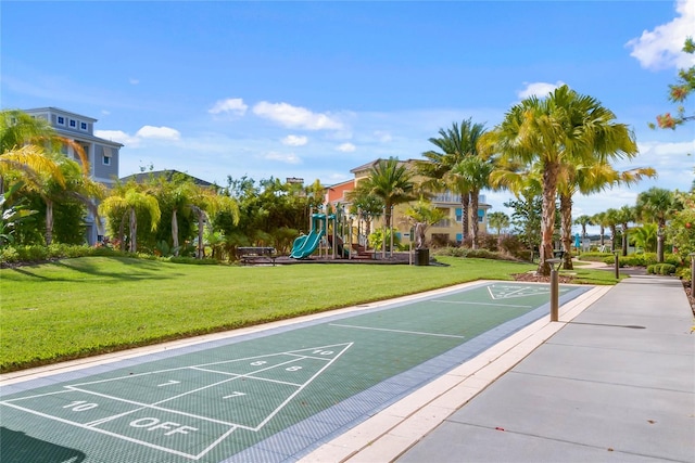 view of home's community featuring a yard and a playground