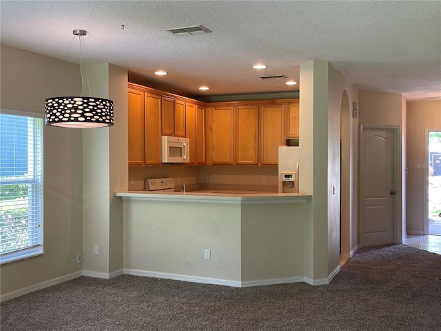 kitchen with light carpet, fridge with ice dispenser, kitchen peninsula, and range