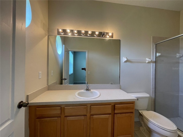 bathroom featuring an enclosed shower, vanity, and toilet