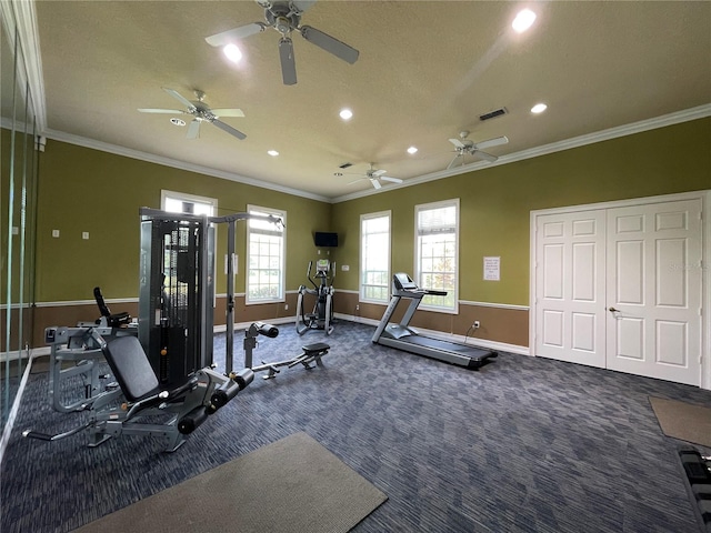 exercise room with dark carpet and ornamental molding