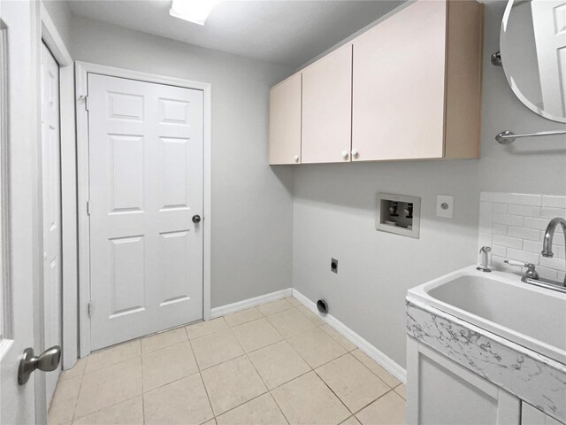 laundry room with cabinets, sink, electric dryer hookup, washer hookup, and light tile patterned flooring