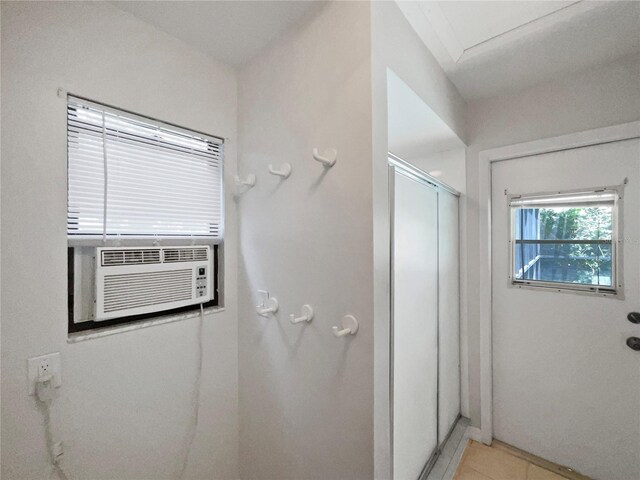 bathroom with tile patterned flooring, a shower with shower door, and cooling unit