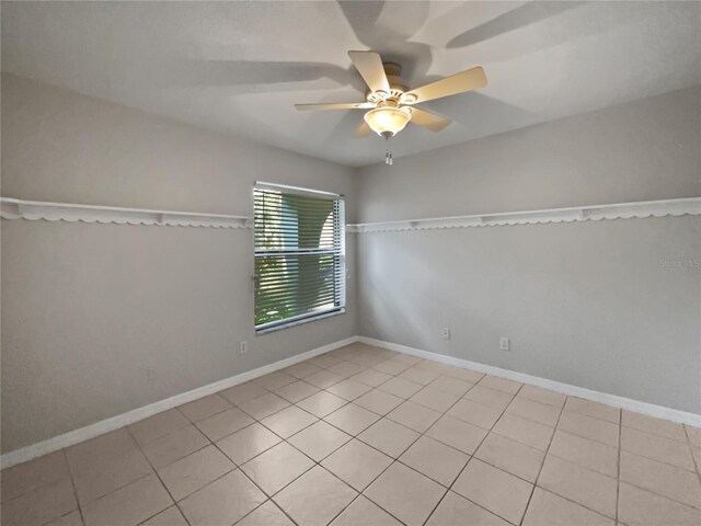 empty room with light tile patterned floors and ceiling fan