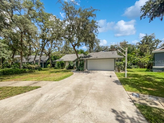 ranch-style house with a garage and a front lawn