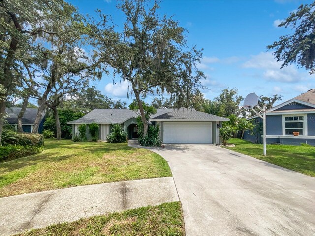 single story home with a garage and a front lawn