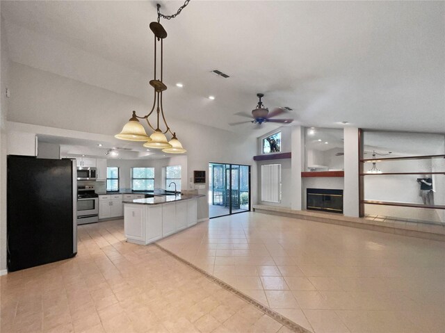 kitchen featuring stainless steel appliances, white cabinetry, sink, ceiling fan, and pendant lighting