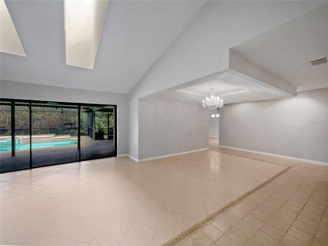 unfurnished room featuring an inviting chandelier and light tile patterned flooring