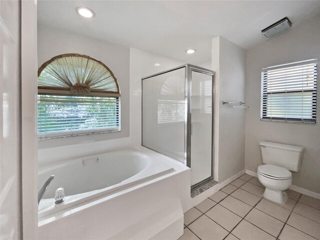 bathroom featuring toilet, independent shower and bath, and tile patterned floors