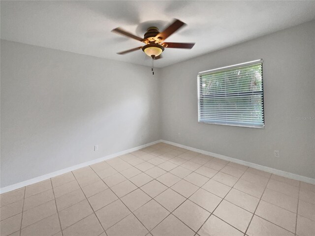 tiled empty room with ceiling fan