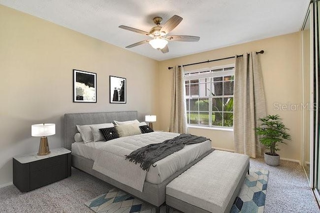 bedroom featuring light colored carpet and ceiling fan