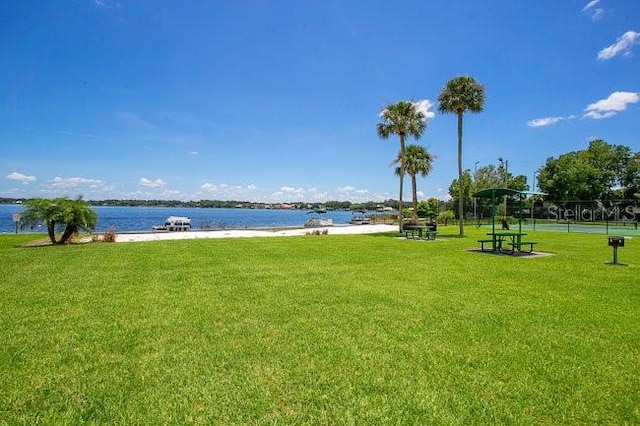 exterior space featuring a water view and a yard